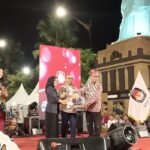 Pita Anjarsari, MPd Ketua KPU Bersama KPU Propinsi Serah Terima Kirab Maskot dan Sosialisasikan Maskot Madiun Kota Kang Osi "Ora Nyoblos Ora Jos"